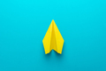 Top View Photo of Yellow Paper Plane on Turquoise Blue Background and Copy Space - PhotoDune Item for Sale