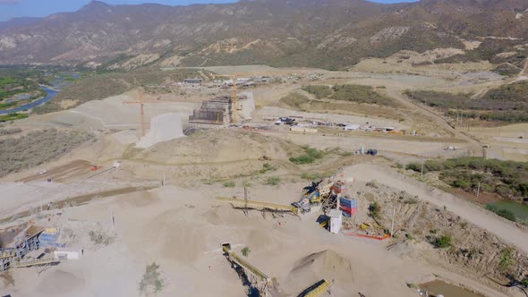 Drone fly Over View of Incomplete Presa Monte Grande Dam Wall Construction Site and Machinery for Ea