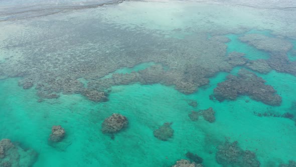 Sideways aerial of stunning coral reef ecosystem with clear turquoise water