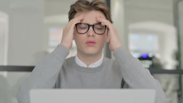 Close Up of Young Man Reacting to Loss While Using Laptop