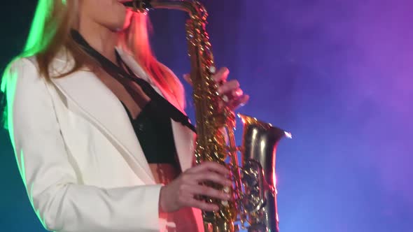 Young Sexy, Blonde Woman Dj in White Jacket and Black Top Playing Music Using Saxophone, Flipping