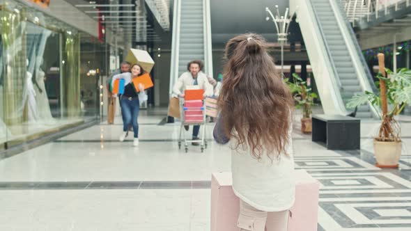 A Little Girl Call Out Of Group People To Shopping.Crazy Shopping at Big Sales