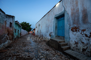 borhood in a small Cuban Town during a cloudy and sunny sunrise.