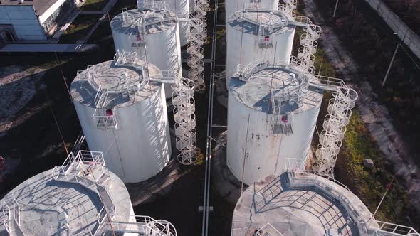 Aerial view of vertical white fuel storage tanks.
