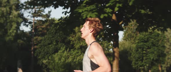 Man runs through forested area