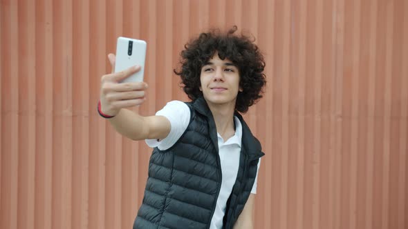 Goodlooking Middle Eastern Teenager Taking Selfie Outdoors Posing for Smartphone Camera