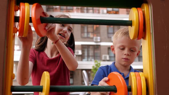 A Boy and a Girl Learn to Count on the Playground