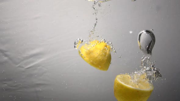 Parts of Lemon Drops Under Water. Fresh Slowmotion