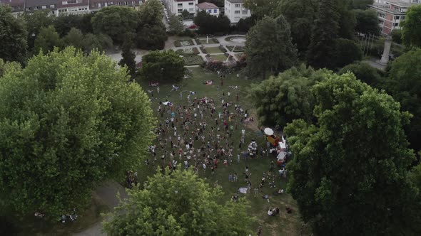 silent disco in the park, Freiburg im Breisgau Germany Dancing to the music aerial shot 4k cinematic