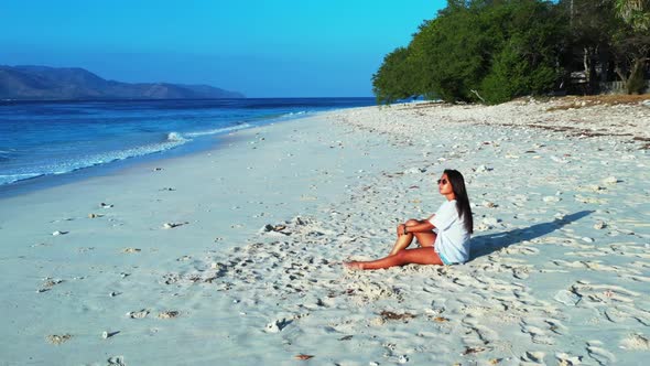 Girls happy and smiling on perfect island beach break by transparent water with white sandy backgrou