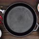 Cast iron pan on a wooden table. A chef lays out food for the frying. Kumquats, Dried Apricots etc. - VideoHive Item for Sale