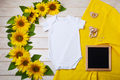 White baby short sleeve bodysuit mockup with sunflowers and black chalkboard - PhotoDune Item for Sale
