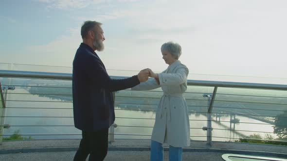 Charming Aged Couple Dancing and Hugging on Observation Point of Park