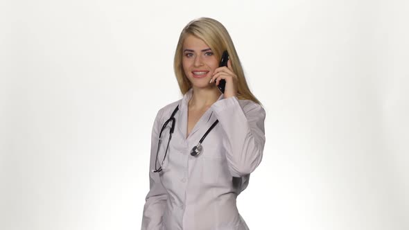 Pretty Doctor Talking on the Phone. White