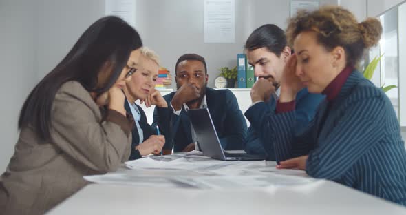 Afroamerican Man Dreaming Sitting at Table During Business Meeting