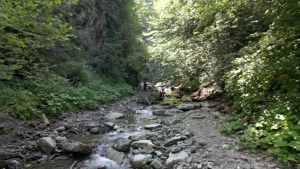 Manyava Ukraine  July 31 2021 People Travelers Walking to Waterfall By Canyon