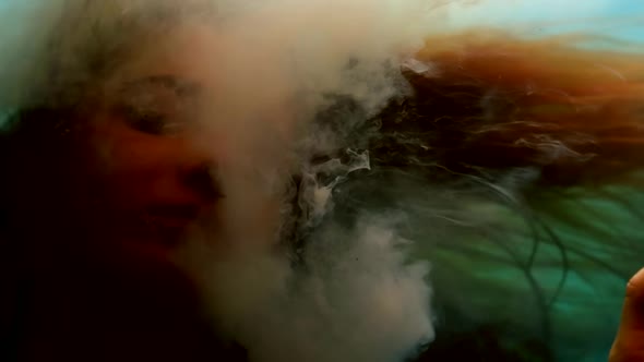 Mysterious Woman is Breathing By White Smoke and Swimming Underwater Closeup of Pretty Face