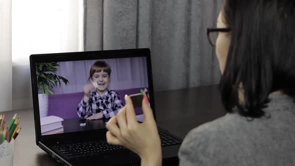 Woman Teacher Making Video Call on Laptop with Little Pupil. Distance Education