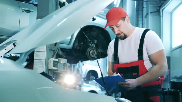 Car Repairman Writing Down Some Notes