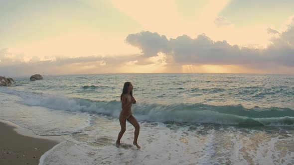 Young Attractive Woman Jogging on the Beach