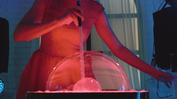 Beautiful Girl Puffs Up a Big Bubble, Then Pierces It with Her Hand, Doing a Show, Close-up