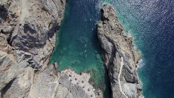 Cretan village blue logons, coral reefs, rocky hills. Aerial mountain view.