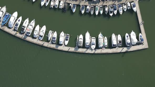 Top down aerial view of boats parking on the boathouse. Beautiful drone forward fly over