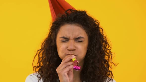 Happy Girl Blowing Party Horn, Celebrating Birthday, Isolated on Background