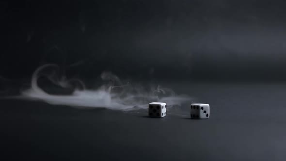 White Dice Thrown Into Smoke