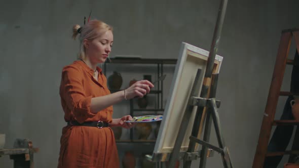 Female Artist Creating Picture Using Palette Knife