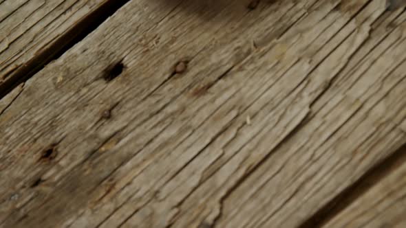 Halved mango and knife on wooden table