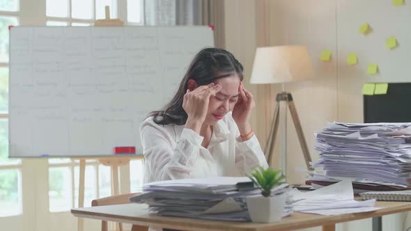 Tired Asian Woman Shaking Her Head While Working Hard With Documents At The Office