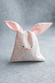 Bag of sweets in shape of Easter bunny with ears on light gray background. - PhotoDune Item for Sale