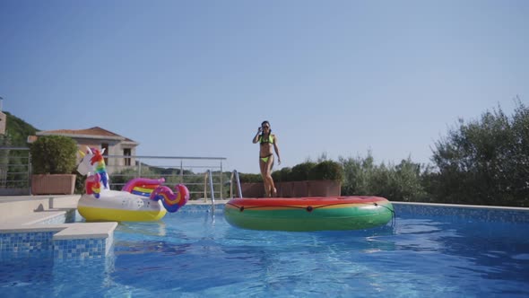 Woman with Inflatable Pool Toys Relax in Swimming Pool