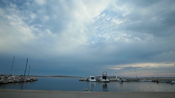 Timelapse of clouds passing over harbour on Croatian island.