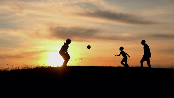 Family Vacation In Nature. Dad, Mom And Son Playing With The Ball.