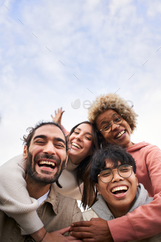 Vertical of a Group of young people looking at the camera outdoors.