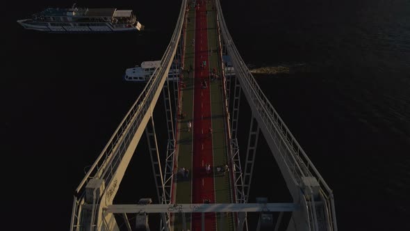 Drone View of a Big Foot Bridge and a Big Ship Sailing Under It Kyiv