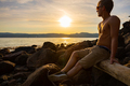 Young Shirtless Man Sitting On Rock During Sunset - PhotoDune Item for Sale