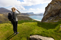 Woman hiking in high mountains and looking at Haukland Beach at Vestvagoy Island at Lofoten, Norway - PhotoDune Item for Sale
