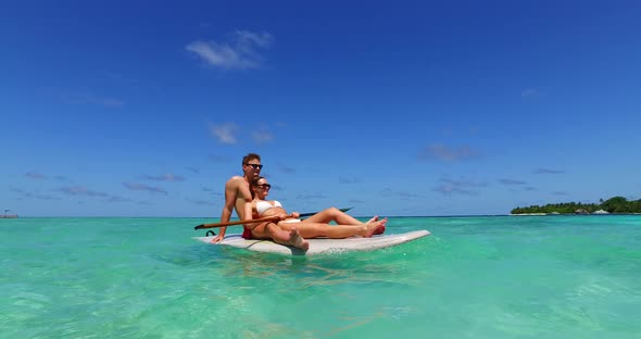 Young couple married on vacation have fun on beach on summer white sandy background 4K