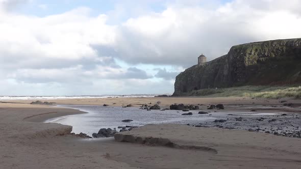 Timelapse of Downhill Beach with Rainbow and Train Passing at the Cliffs in County Londonderry in
