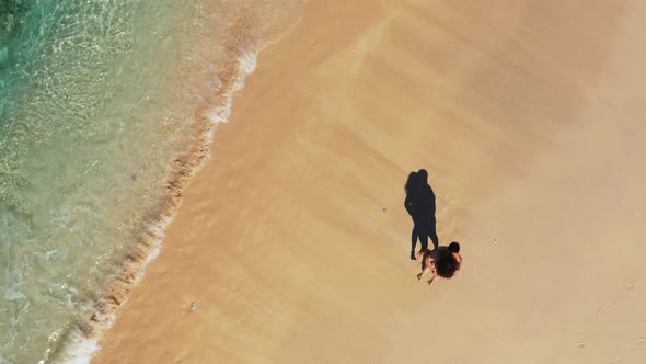 Fun man and woman on romantic honeymoon spend quality time on beach on summer white sandy background