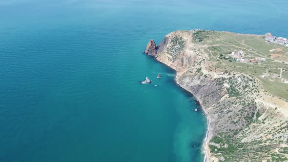 Aerial View From Above on Calm Azure Sea and Volcanic Rocky Shores