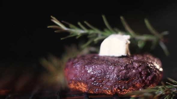 meat on grill. Juicy Burger grilled with a sprig of rosemary