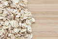 Close up picture of whole grain oats on a wooden background - PhotoDune Item for Sale