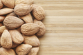 Close up picture of almonds on a wooden background - PhotoDune Item for Sale