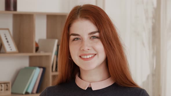 Portrait of Lovely Young Red Hair Female Student Standing in Library Attractive Student Smiling