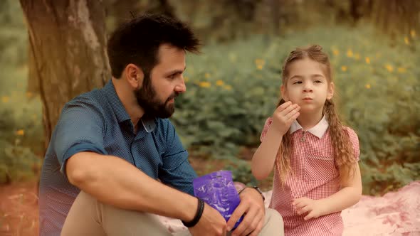 Fathers Day.Happy Family Father With Child Girl Leisure.Cute Little Daughter With Dad Eat Candy.