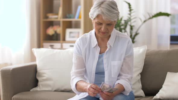 Senior Woman with Money and Bills at Home 